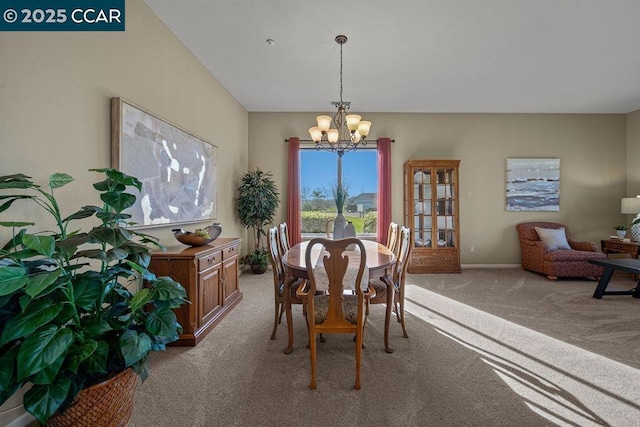 dining room with an inviting chandelier and light carpet