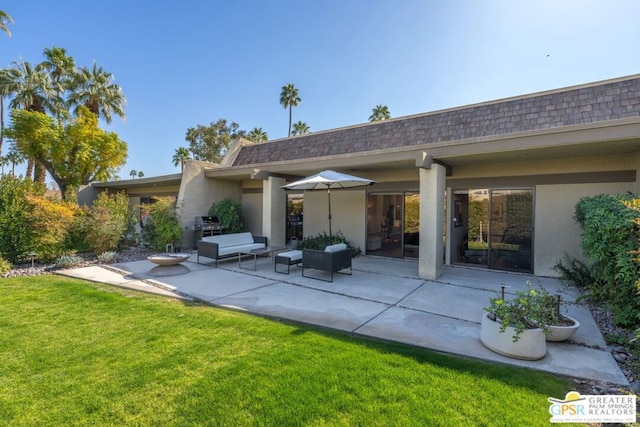 rear view of property with a patio area and a lawn