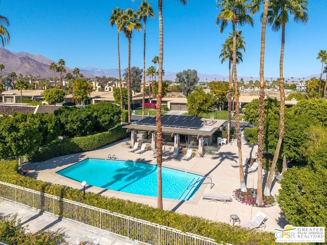 view of swimming pool with a mountain view and a patio area