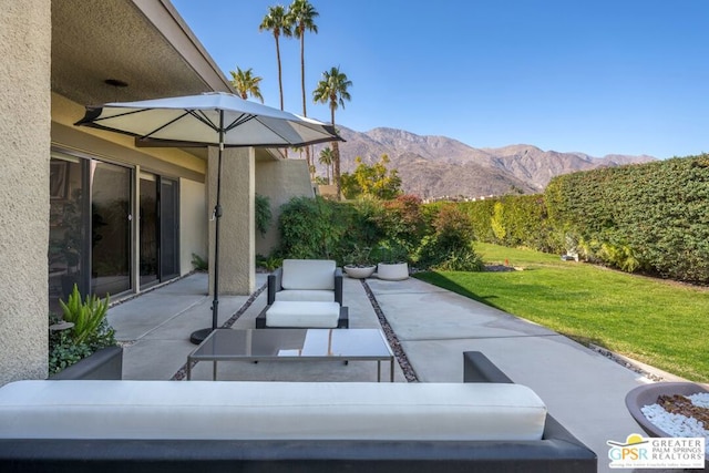 view of patio / terrace with a mountain view and an outdoor hangout area