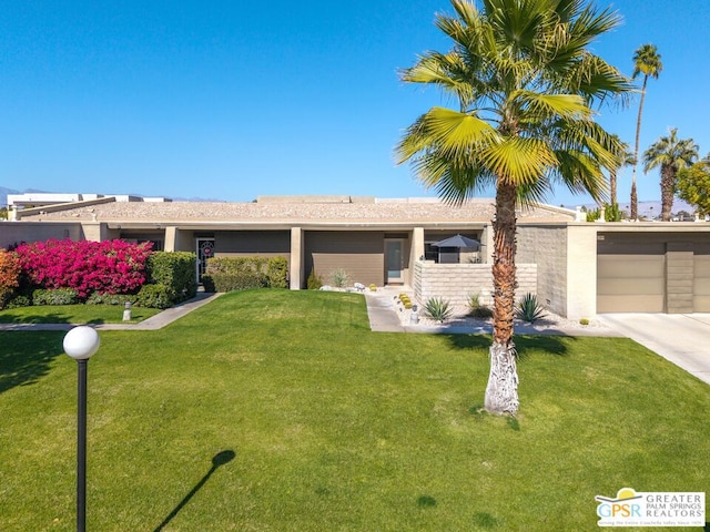 ranch-style home featuring a garage and a front yard