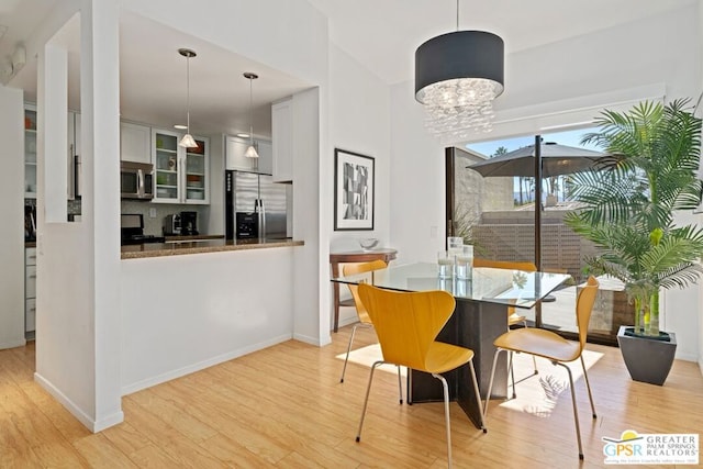 dining room with a notable chandelier and light hardwood / wood-style floors