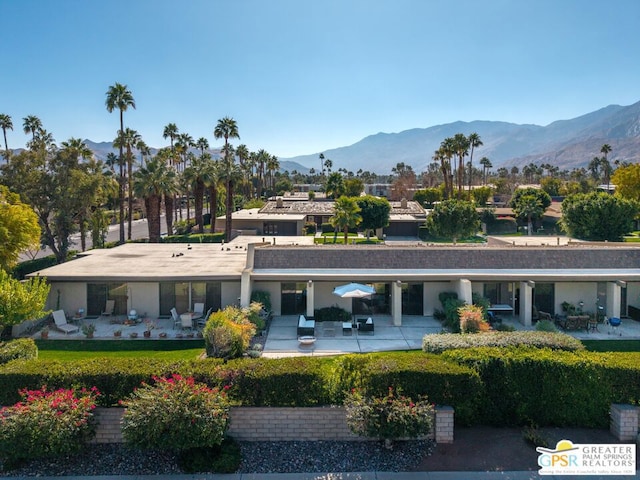 back of house featuring a mountain view and a patio area