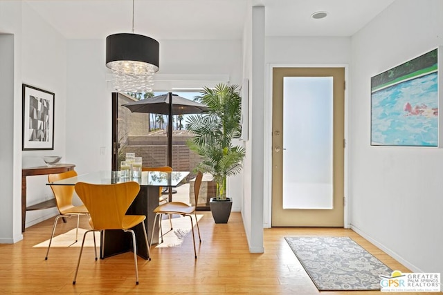 dining room with a chandelier and light hardwood / wood-style floors