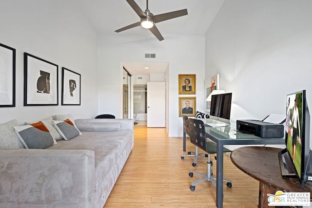 office featuring ceiling fan, high vaulted ceiling, and light hardwood / wood-style floors