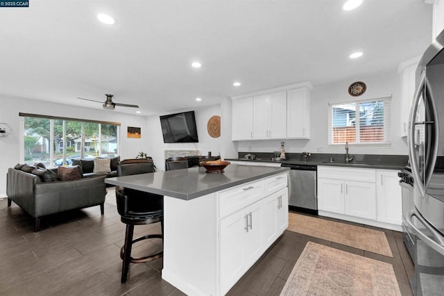 kitchen featuring white cabinetry, appliances with stainless steel finishes, sink, and a kitchen island