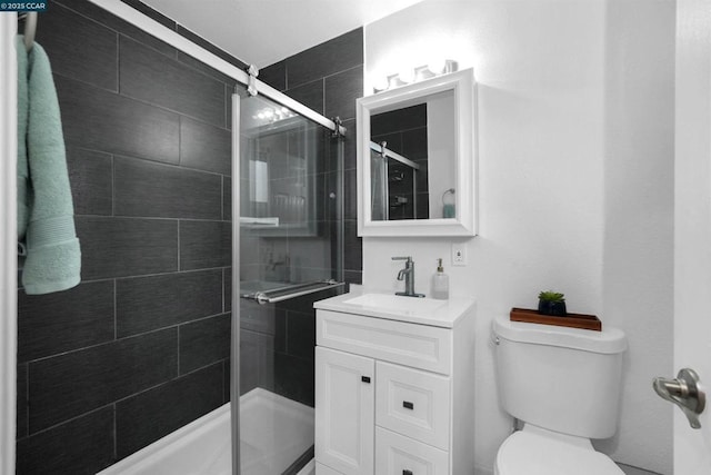 bathroom featuring vanity, toilet, and an enclosed shower