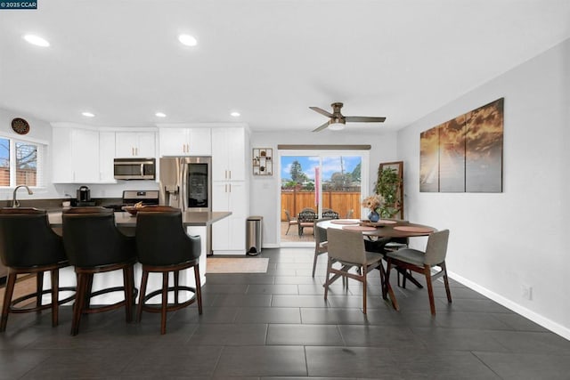 dining room with sink and ceiling fan