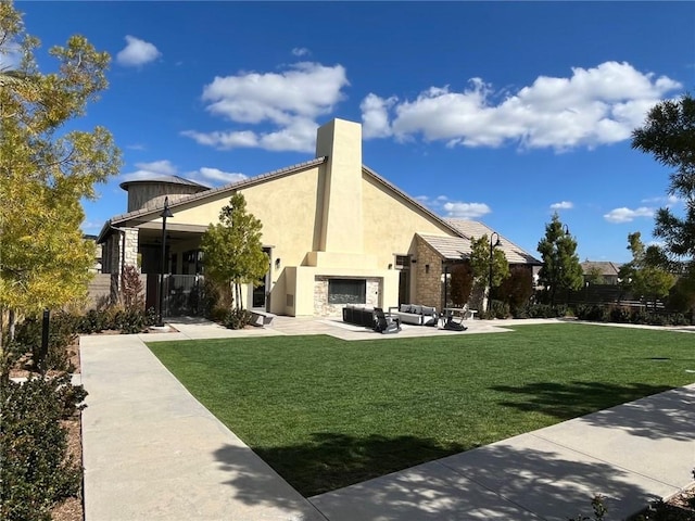 39767 Larkspur Ter, Temecula, CA 92591 - rear view of house with stone siding, a yard, an outdoor living space with a fireplace, and stucco siding