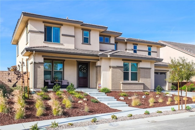 39767 Larkspur Ter, Temecula, CA 92591 - prairie-style home with a porch, brick siding, and stucco siding