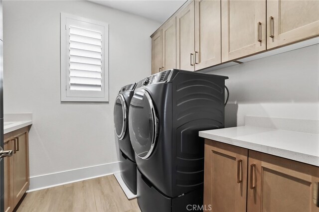39767 Larkspur Ter, Temecula, CA 92591 - laundry area featuring cabinet space, independent washer and dryer, and light wood-style flooring