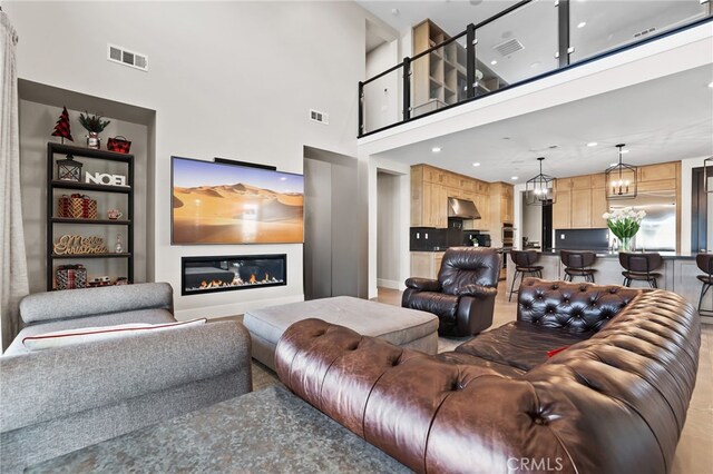 39767 Larkspur Ter, Temecula, CA 92591 - living area featuring a glass covered fireplace, a high ceiling, and recessed lighting