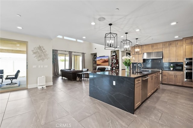 39767 Larkspur Ter, Temecula, CA 92591 - kitchen featuring dark countertops, stainless steel appliances, under cabinet range hood, open floor plan, and recessed lighting
