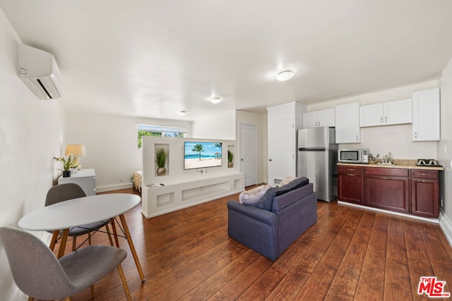 living room featuring sink, dark hardwood / wood-style floors, and a wall mounted air conditioner