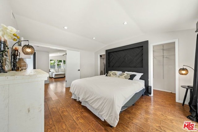 bedroom with hardwood / wood-style flooring and vaulted ceiling