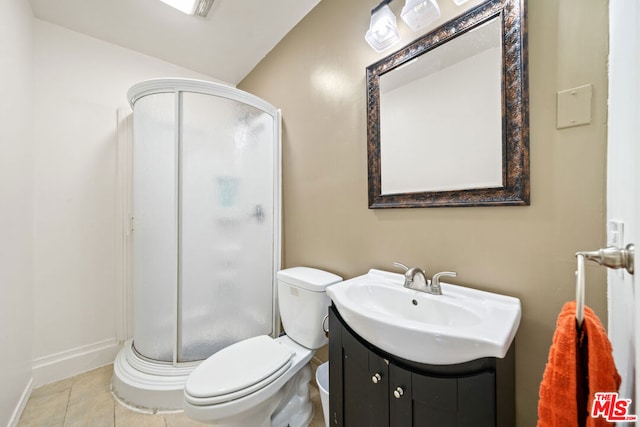 bathroom featuring vanity, tile patterned flooring, toilet, and walk in shower