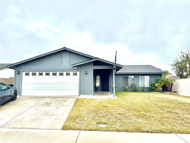 single story home with a garage and a front lawn