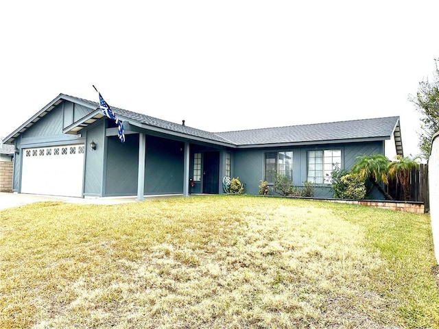 ranch-style home featuring a garage and a front lawn