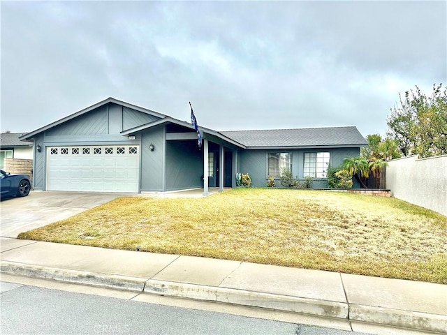 single story home featuring a garage and a front lawn