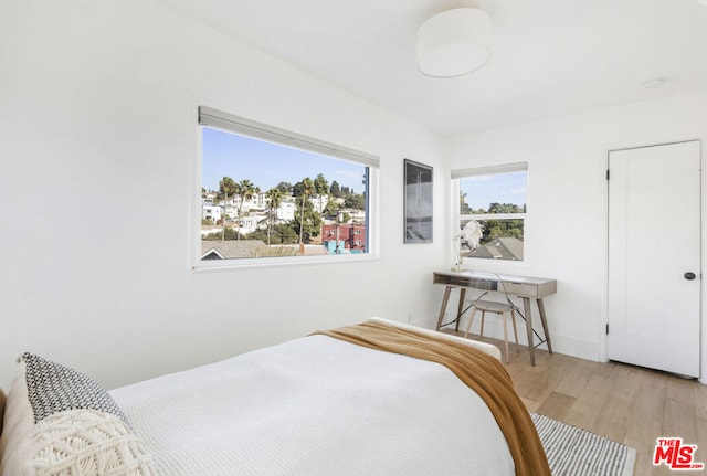 bedroom with light wood-type flooring