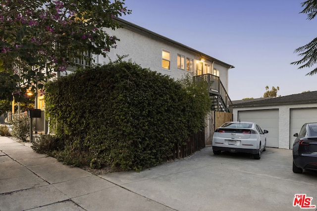 property exterior at dusk with a garage