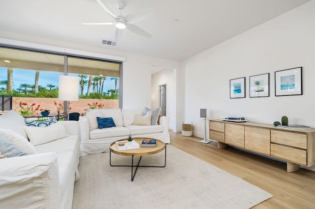 living room featuring ceiling fan and light wood-type flooring