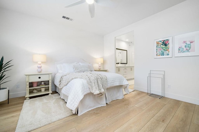 bedroom featuring ceiling fan, ensuite bath, and light hardwood / wood-style flooring