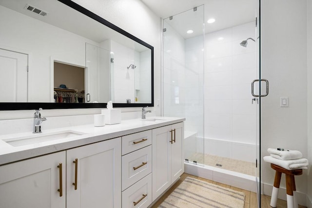 bathroom with vanity, wood-type flooring, and an enclosed shower