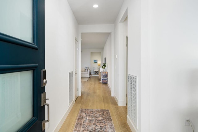 corridor featuring light hardwood / wood-style floors