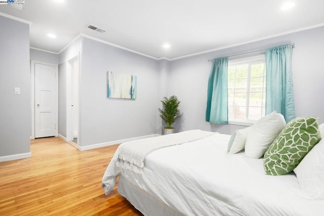 bedroom with hardwood / wood-style flooring and ornamental molding