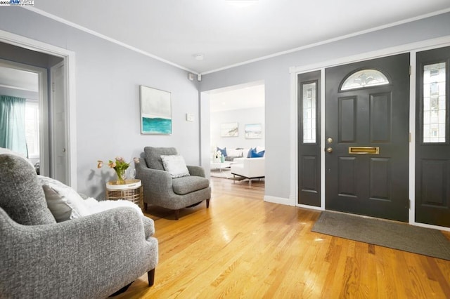 foyer entrance featuring ornamental molding and wood-type flooring