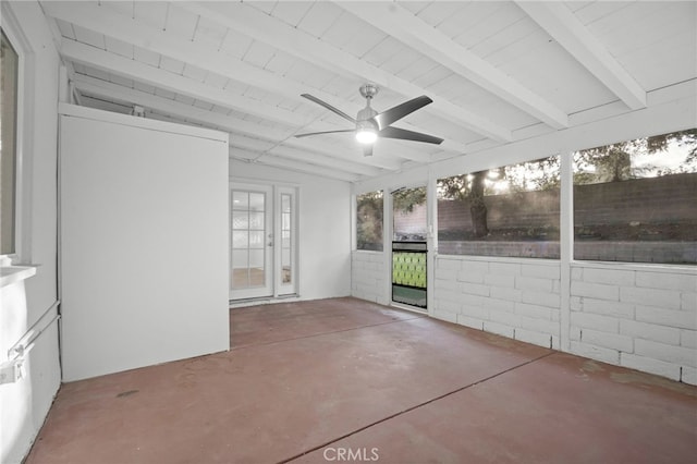 unfurnished sunroom featuring beam ceiling and ceiling fan