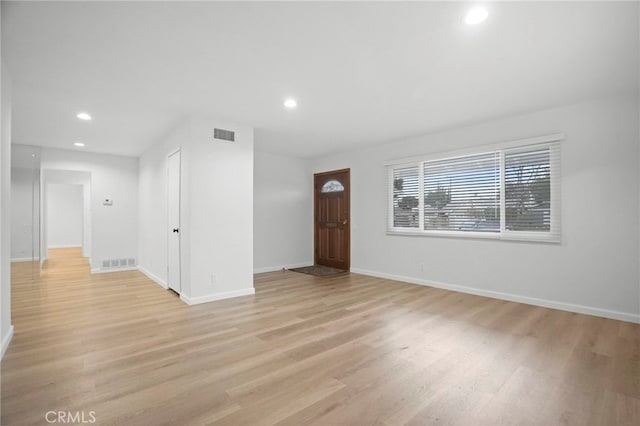 spare room featuring light hardwood / wood-style flooring