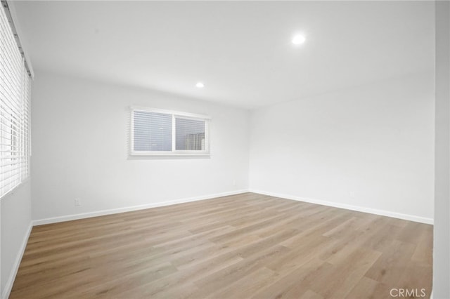 spare room featuring light wood-type flooring