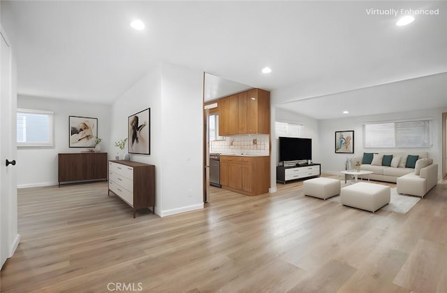 living room with lofted ceiling and light hardwood / wood-style floors