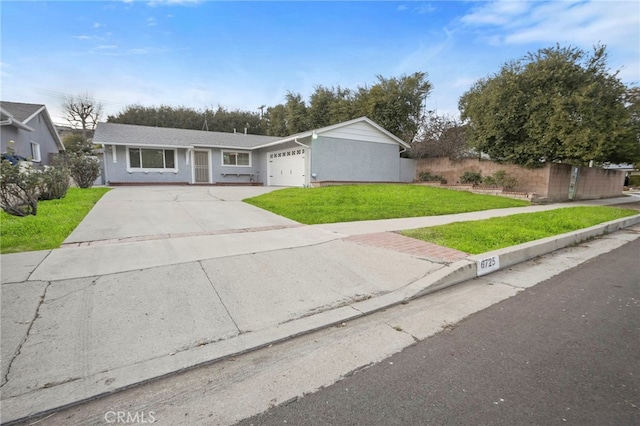 ranch-style house featuring a garage and a front yard