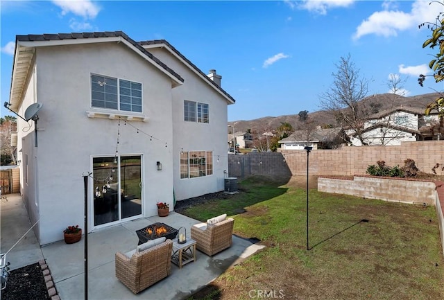 back of house with cooling unit, a patio, a fire pit, and a lawn