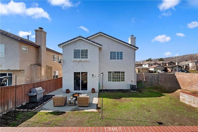 back of house featuring cooling unit, an outdoor living space, a yard, and a patio