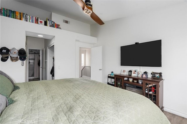 bedroom featuring hardwood / wood-style flooring, vaulted ceiling, and ceiling fan