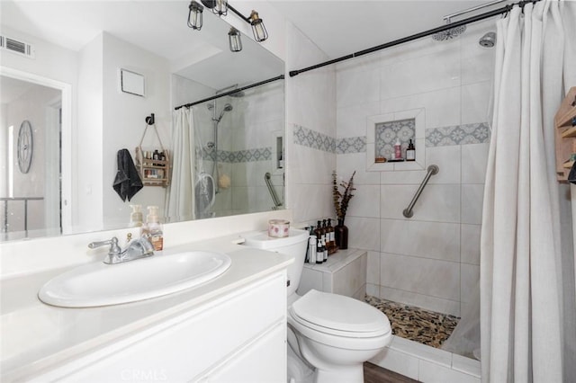 bathroom featuring vanity, toilet, and a shower with shower curtain