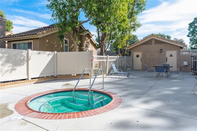 view of pool featuring a community hot tub and a patio area