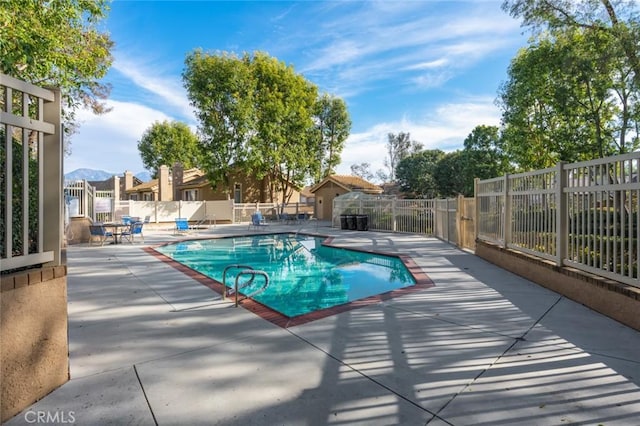 view of pool featuring a mountain view and a patio area