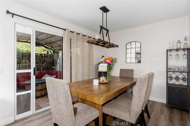 dining space featuring wood-type flooring