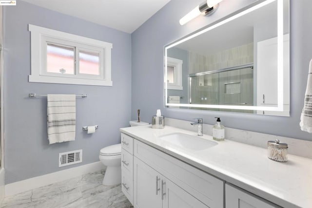 bathroom featuring vanity, toilet, and walk in shower