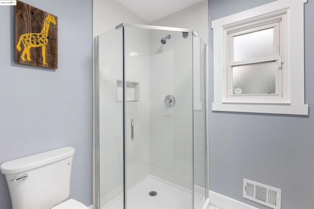 bathroom featuring an enclosed shower and toilet