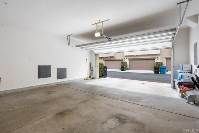 garage featuring a garage door opener and electric panel