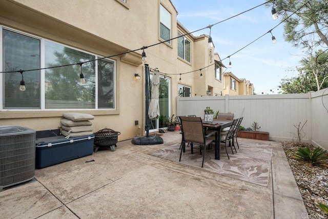 view of patio featuring central AC unit and an outdoor fire pit