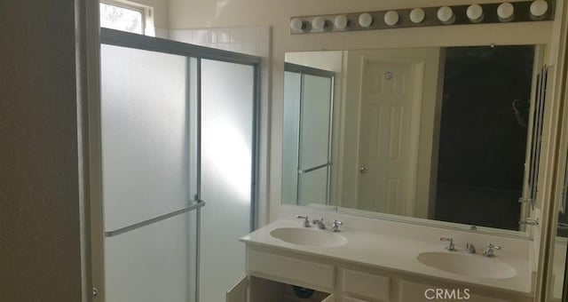 bathroom featuring an enclosed shower and vanity