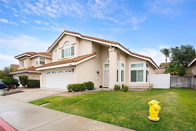 mediterranean / spanish home featuring a garage and a front lawn