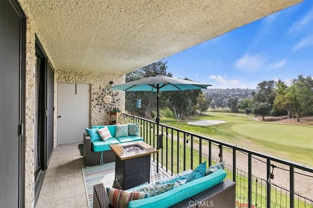 balcony featuring view of golf course and an outdoor hangout area